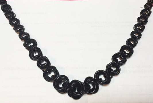 Black anodized aluminum graduated mobius flower necklace